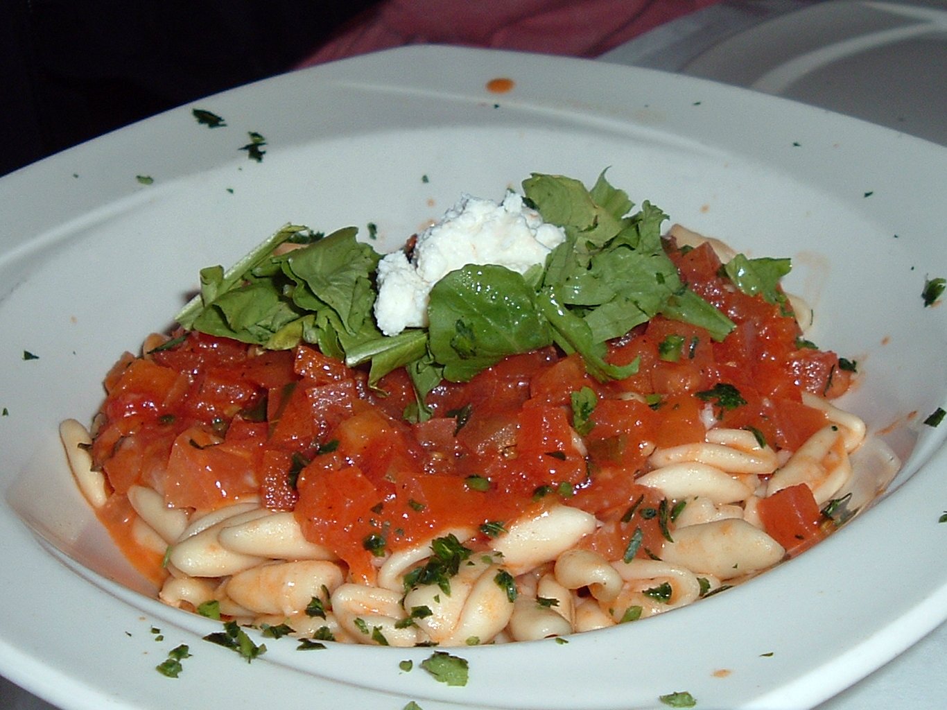 Pasta with tomato sauce, feta cheese and fresh herbs